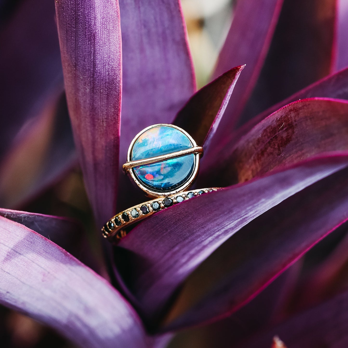 An 18K Rose Gold Offset Ring with a Australian Black Opal and Black diamonds.