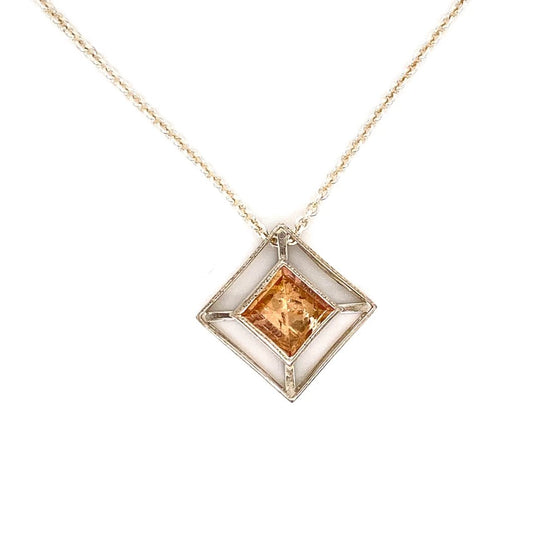 A sterling silver pendant featuring one bezel set square shaped straw topaz on a 16 inch silver chain. This necklace was designed and made by Sydney Strong.